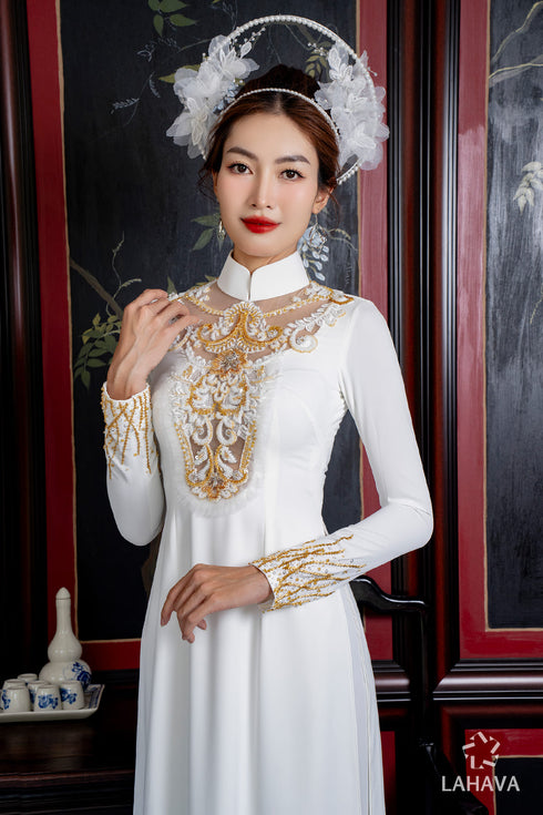 White wedding ao dai features intricate gold beadwork