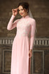Pink ao dai with white lace patterns