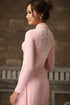 Pink ao dai with white lace patterns
